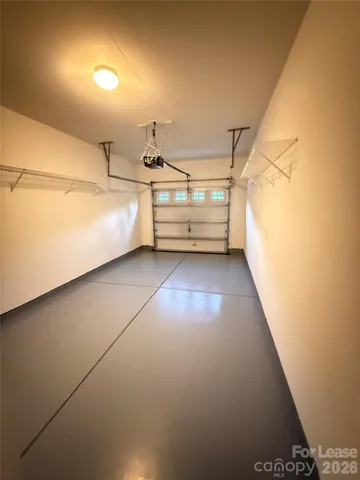 a view of a room with racks on the wall and a window