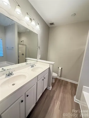 a spacious bathroom with a double vanity sink and a mirror