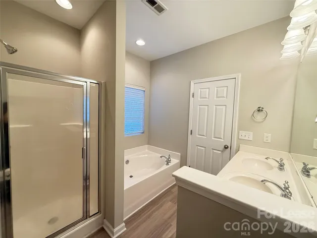 a bathroom with a tub and shower