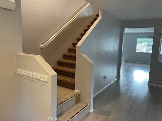 a view of entryway and hall with wooden floor