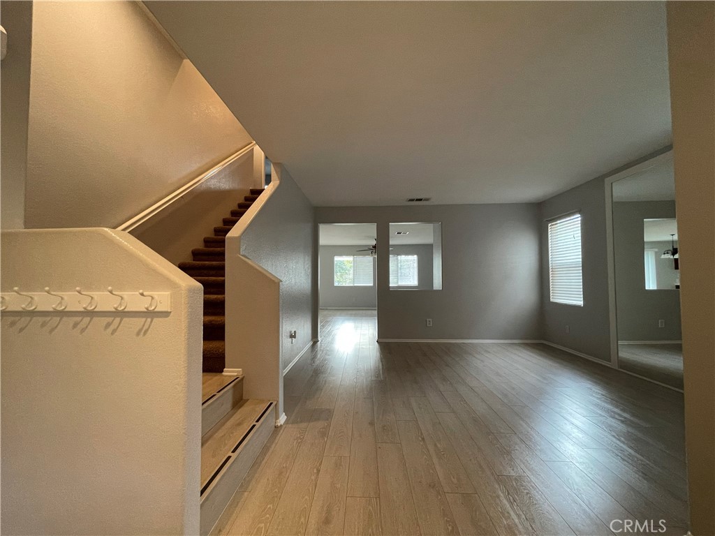 38017 Greenleaf Place Murrieta, CA 92562 - Photo 16 of 37 a view of an empty room with wooden floor and a window