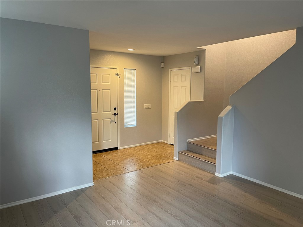 38017 Greenleaf Place Murrieta, CA 92562 - Photo 17 of 37 an empty room with wooden floor and windows