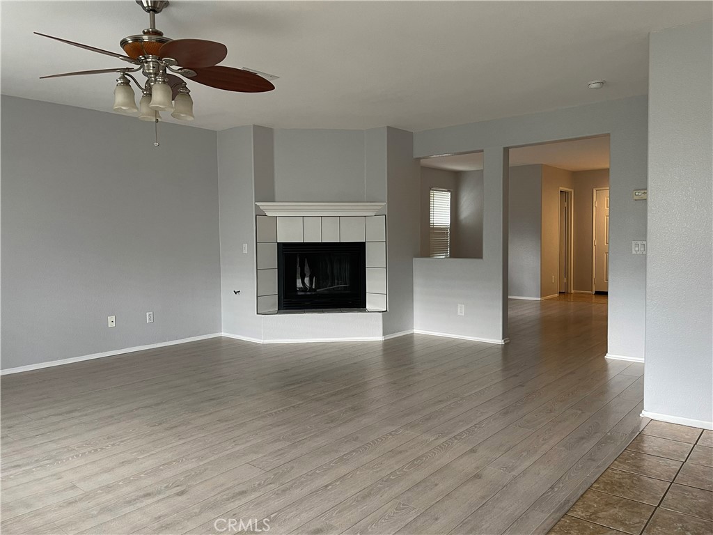 38017 Greenleaf Place Murrieta, CA 92562 - Photo 19 of 37 a view of an empty room with a fireplace and a window