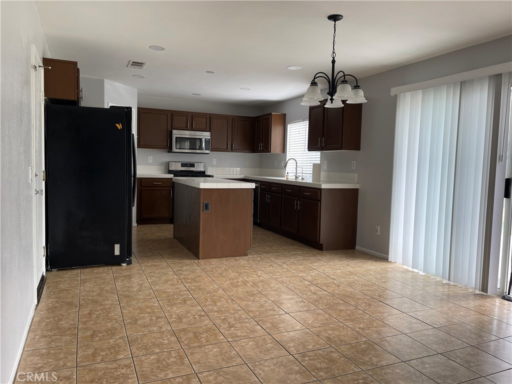 38017 Greenleaf Place Murrieta, CA 92562 - Photo 21 of 37 a kitchen with stainless steel appliances granite countertop a refrigerator and a stove