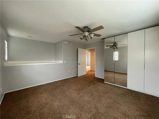 an empty room with a empty space and windows