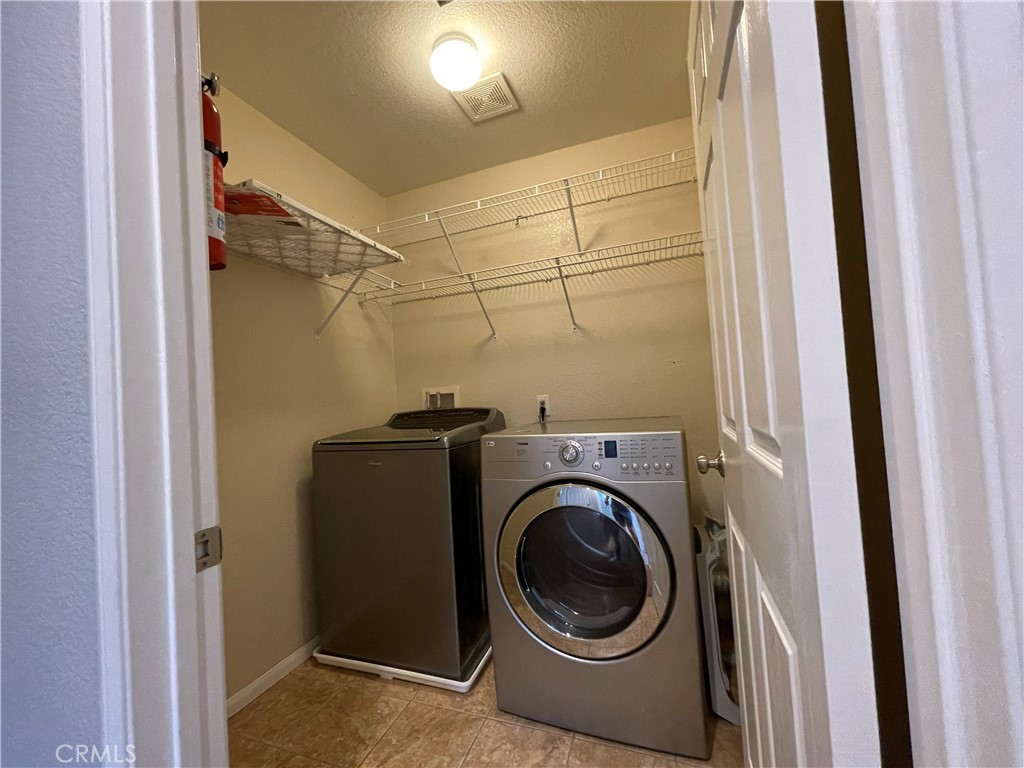 38017 Greenleaf Place Murrieta, CA 92562 - Photo 29 of 37 a utility room with dryer and washer