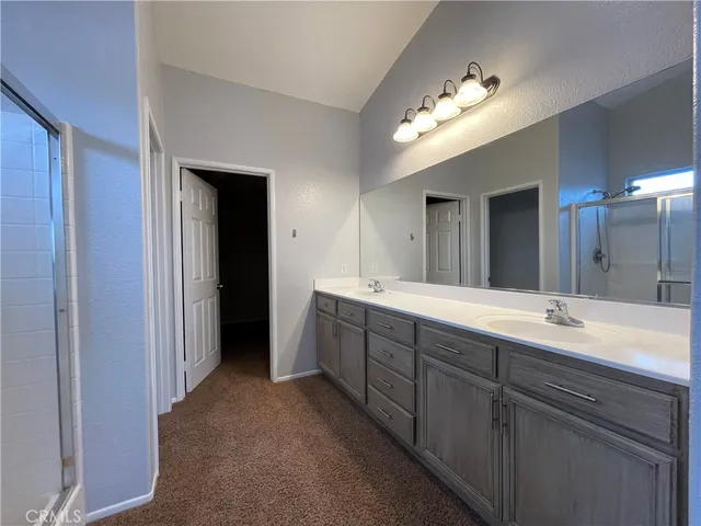 a spacious bathroom with a double vanity sink and a mirror