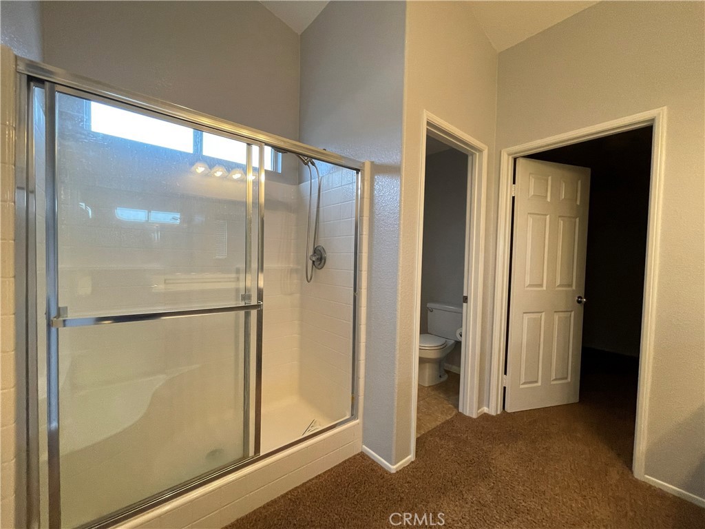 38017 Greenleaf Place Murrieta, CA 92562 - Photo 33 of 37 a bathroom with a glass shower door