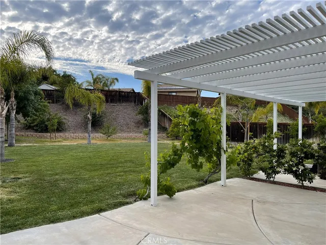 a backyard of a house with plants and outdoor seating
