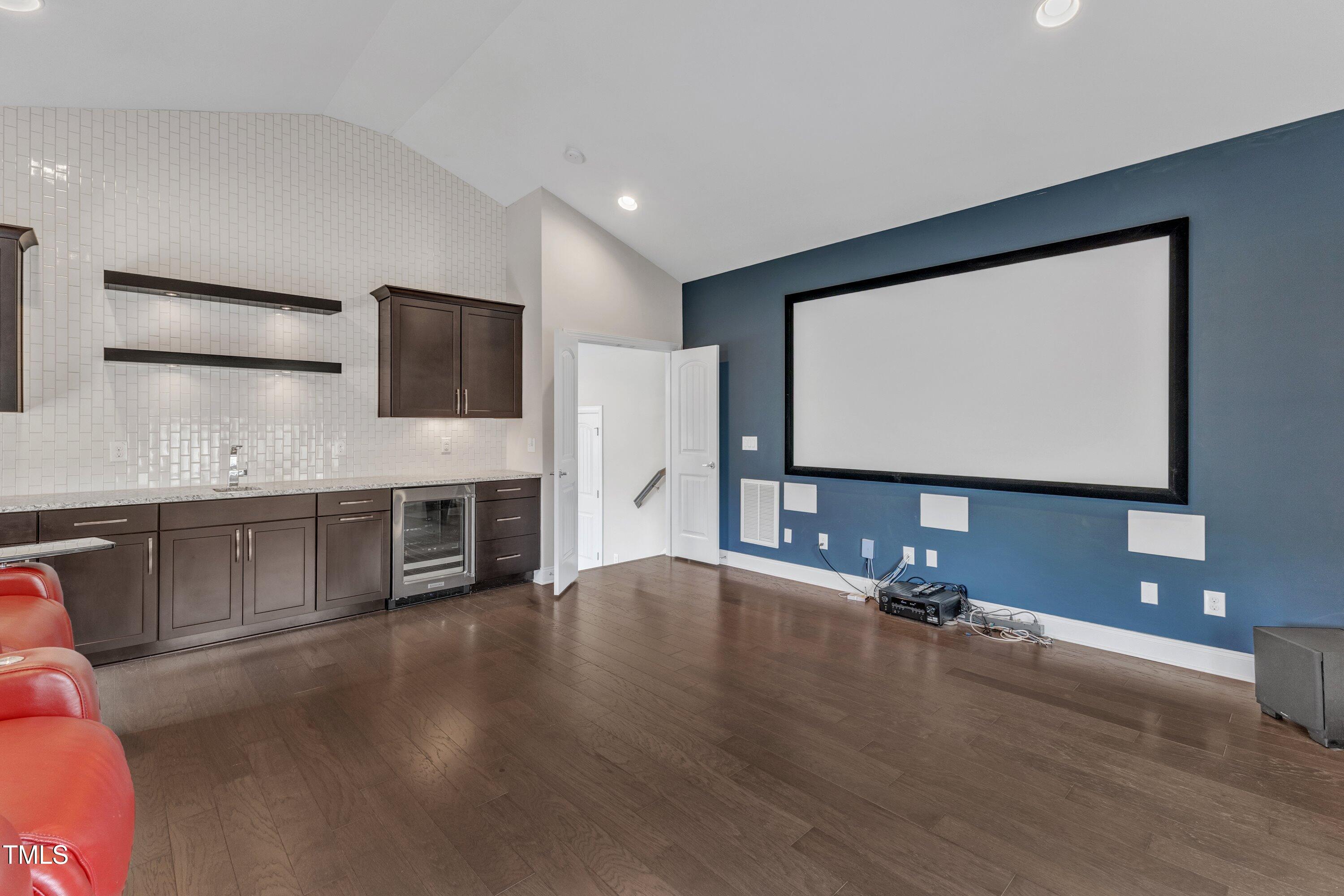 8121 Greys Landing Way Raleigh, NC 27615 - Photo 41 of 95 a living room with a flat screen tv a rug and gym equipment