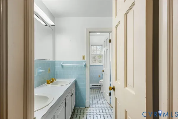 a white toilet sitting next to a bathroom sink