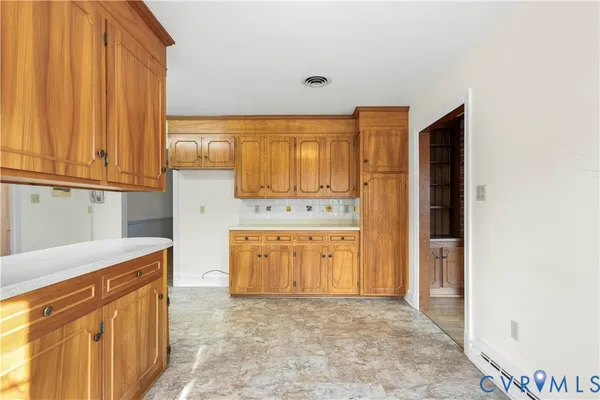 a view of empty room with wooden floor and fireplace
