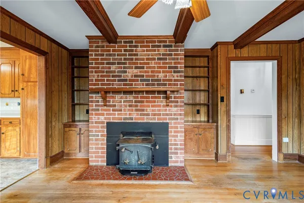 an empty room with window and ceiling fan