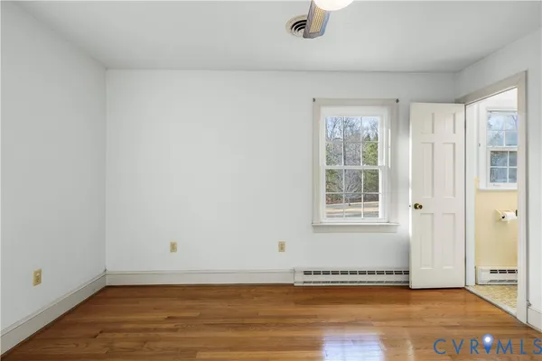 a view of a room with wooden floor and a sink
