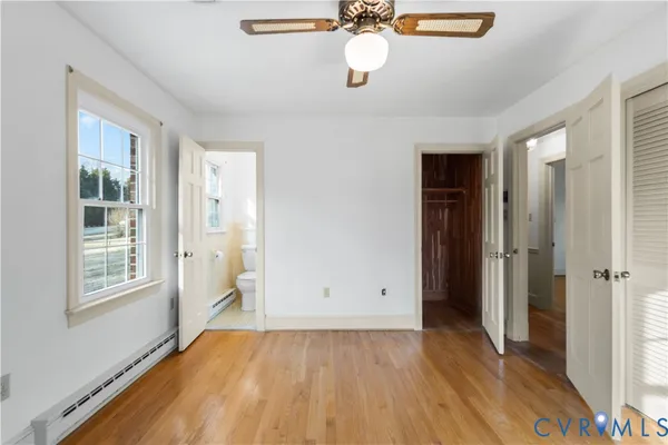 a view of a room with a large window and wooden floor