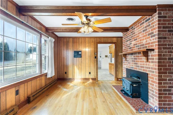 a view of hallway with wooden floor and chandelier