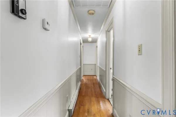 a view of a hallway with wooden floor and staircase