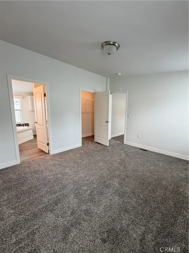 9080 Bloomfield Avenue, Unit 145 Cypress, CA 90630 - Photo 17 of 26 an empty room with an entryway and chandelier