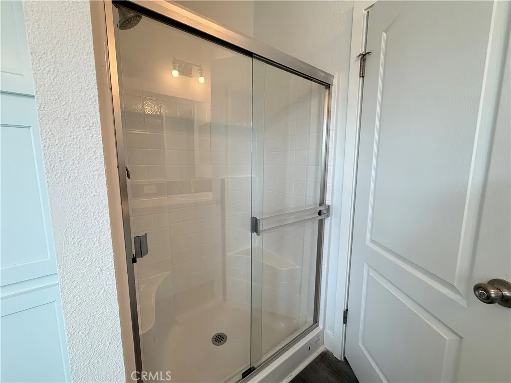 9080 Bloomfield Avenue, Unit 145 Cypress, CA 90630 - Photo 22 of 26 a bathroom with a glass shower door