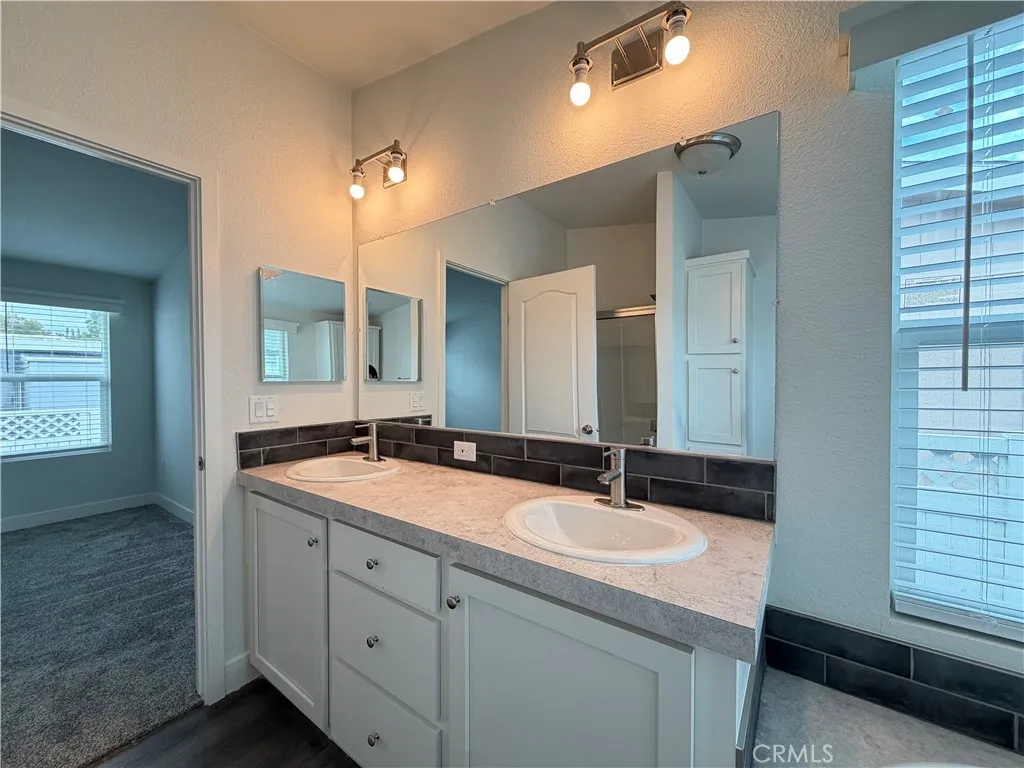 9080 Bloomfield Avenue, Unit 145 Cypress, CA 90630 - Photo 23 of 26 a bathroom with a sink double vanity and a mirror