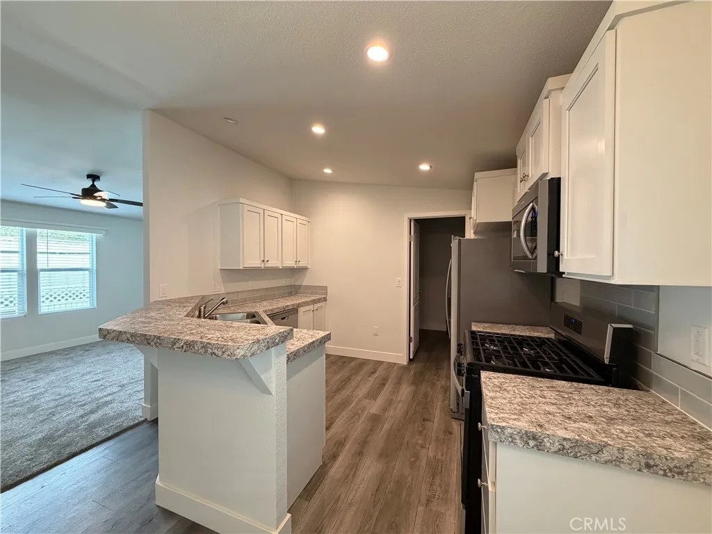 9080 Bloomfield Avenue, Unit 145 Cypress, CA 90630 - Photo 7 of 26 a kitchen with a stove and a refrigerator