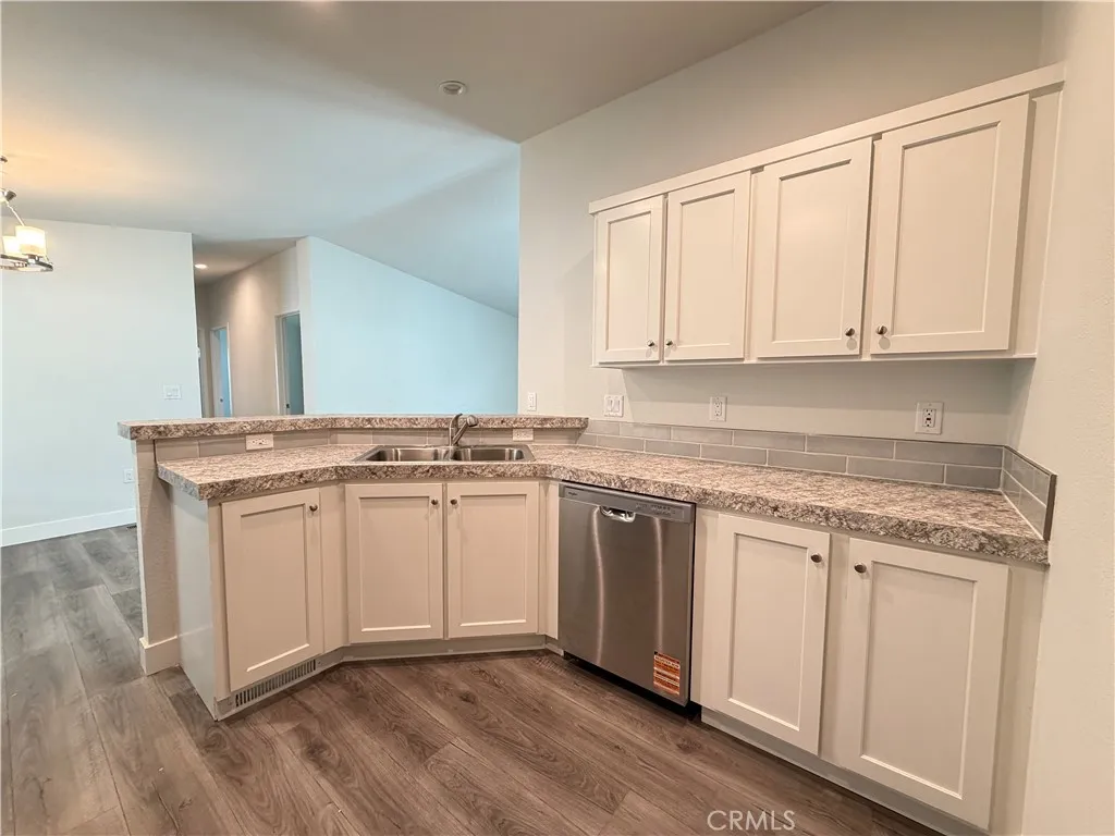9080 Bloomfield Avenue, Unit 145 Cypress, CA 90630 - Photo 9 of 26 a kitchen with granite countertop white cabinets and white appliances