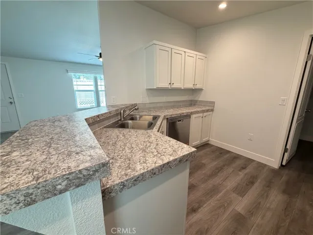 a view of a kitchen with dishwasher and wooden floor
