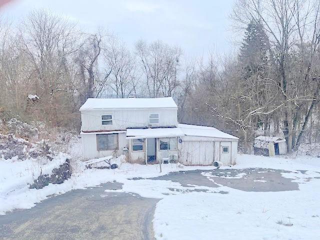 3064 Sylvan Road Ambridge, PA 15003 - Photo 2 of 4 a front view of a house with a yard covered with snow and trees