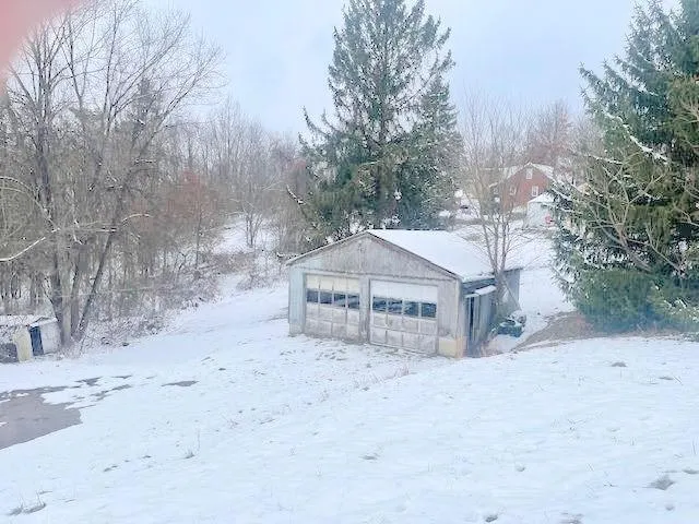a view of a house with a snow in the yard