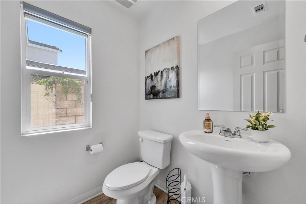 26538 San Jacinto Road Menifee, CA 92585 - Photo 15 of 34 a bathroom with a toilet sink and mirror