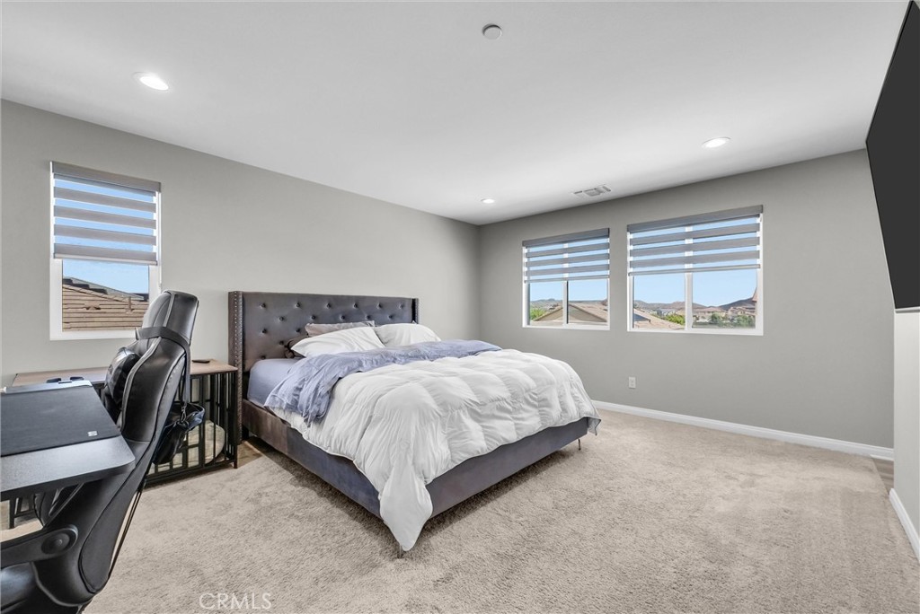 26538 San Jacinto Road Menifee, CA 92585 - Photo 24 of 34 a large bed sitting in a bedroom next to a window