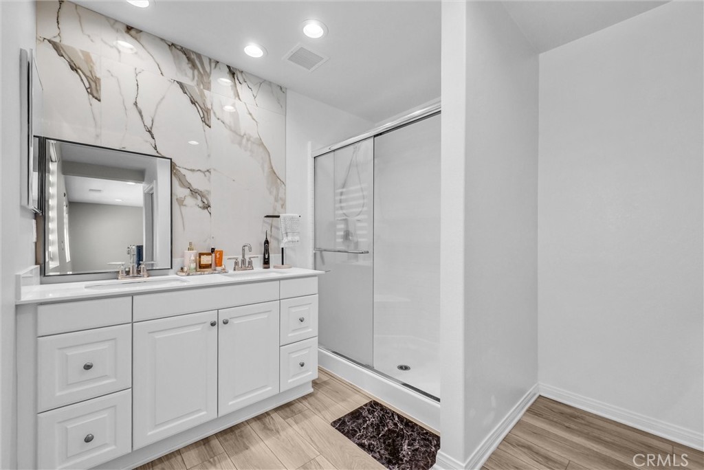 26538 San Jacinto Road Menifee, CA 92585 - Photo 27 of 34 a bathroom with a double vanity sink and mirror