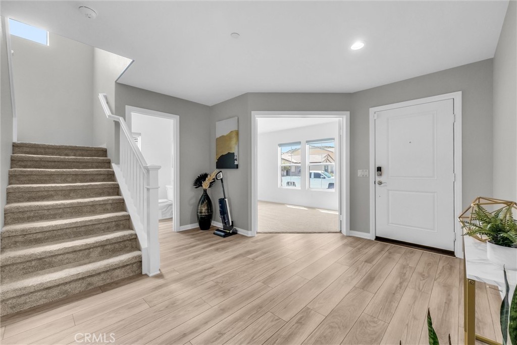26538 San Jacinto Road Menifee, CA 92585 - Photo 5 of 34 a view of an empty room with wooden floor and stairs