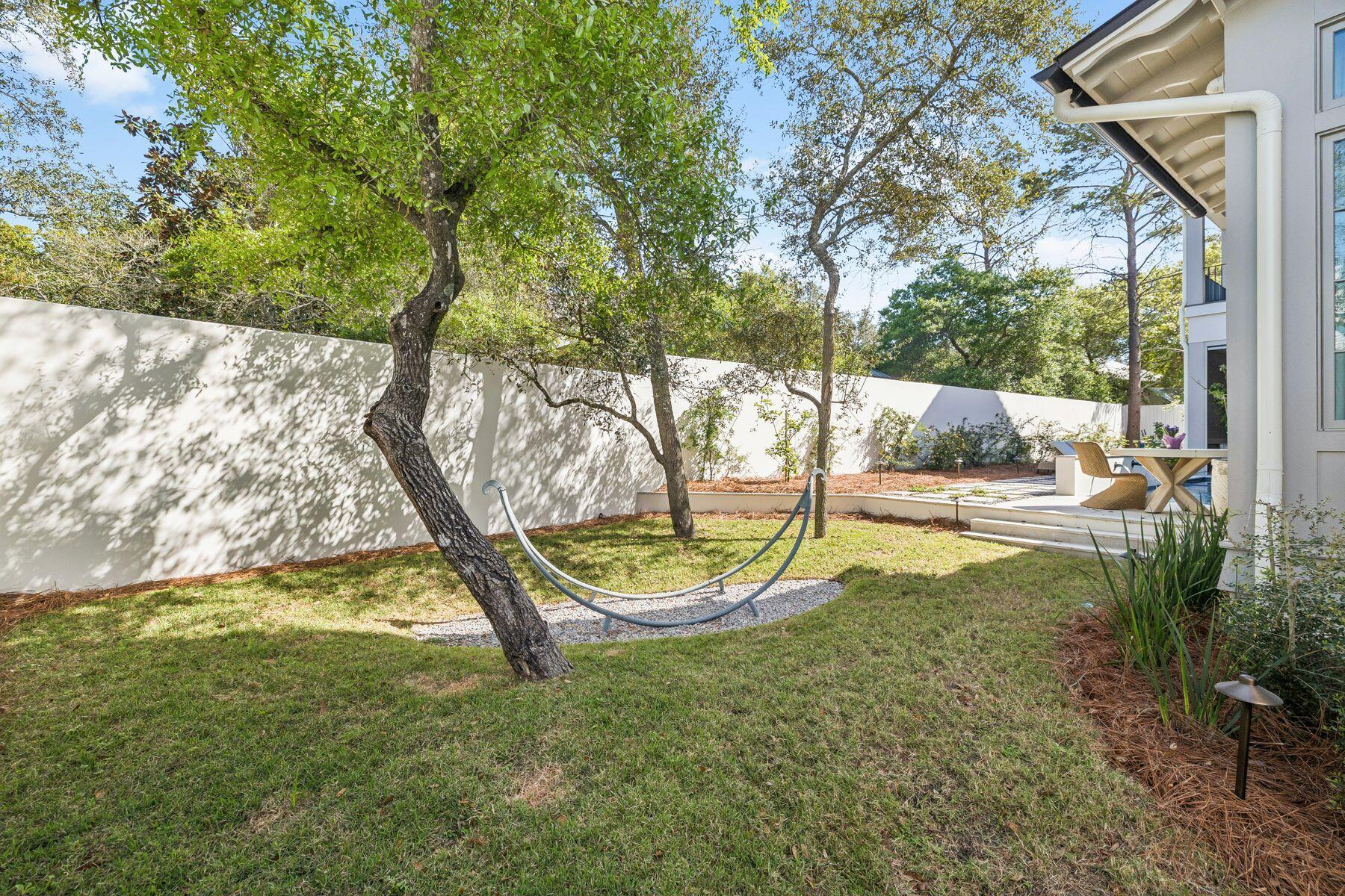 215 Dogwood Street Santa Rosa Beach, FL 32459 - Photo 39 of 91 a backyard of a house with a yard and outdoor seating