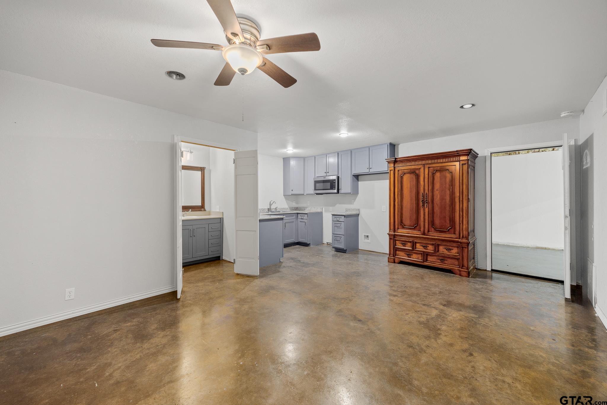 1428 Hagan Road Whitehouse, TX 75791 - Photo 12 of 37 a view of a livingroom with a fireplace a ceiling fan and wooden floor