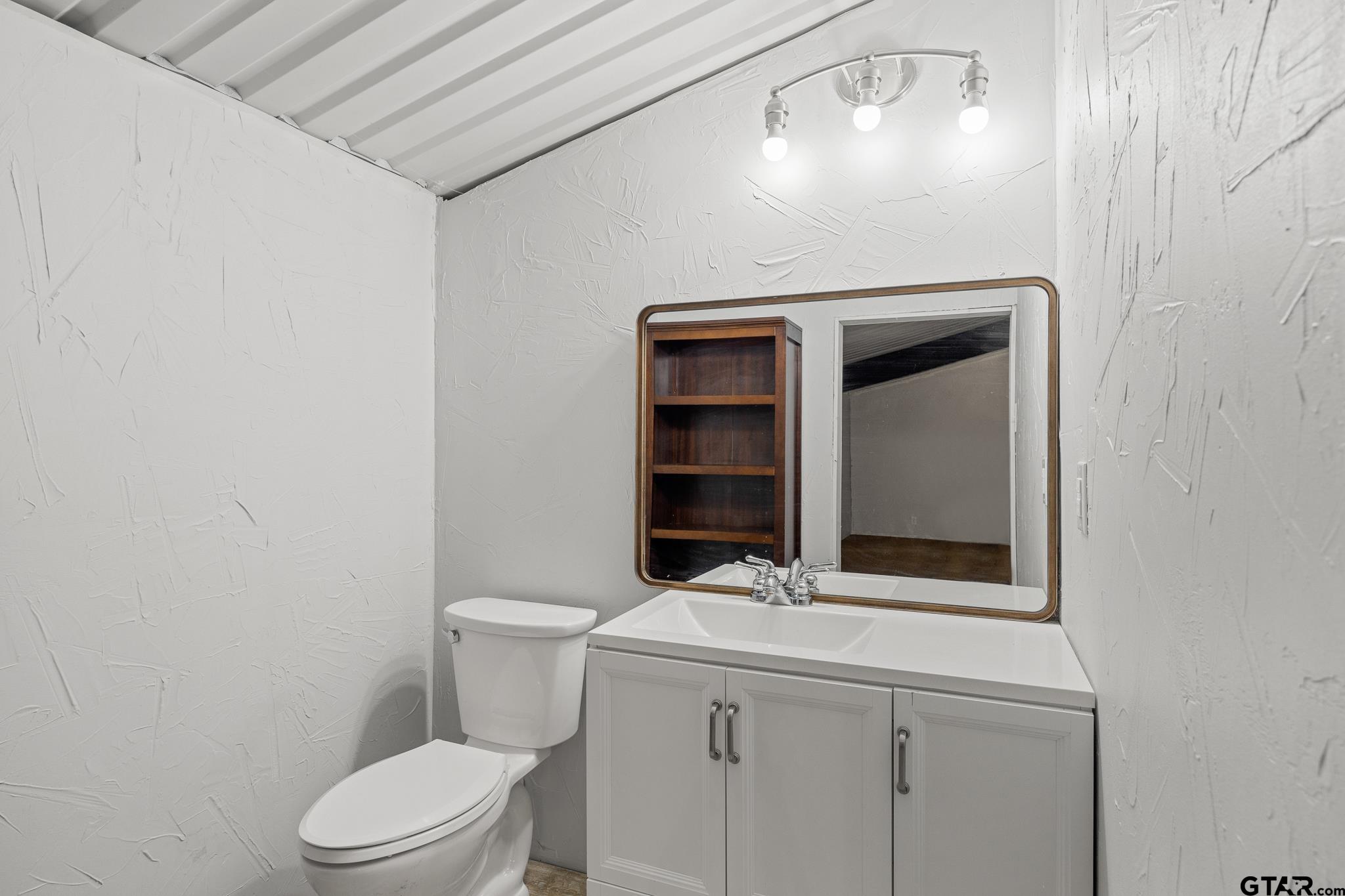 1428 Hagan Road Whitehouse, TX 75791 - Photo 17 of 37 a bathroom with a toilet sink and vanity