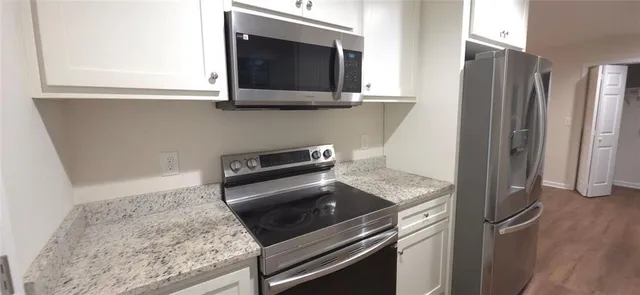 a kitchen with a stove and a microwave
