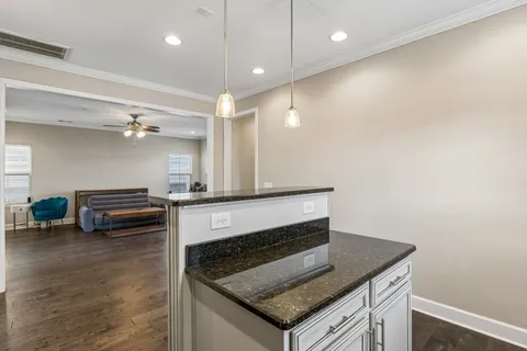 a kitchen with sink stove and cabinets