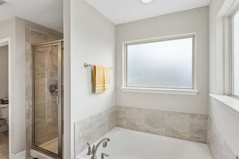a bath tub sitting next to a window