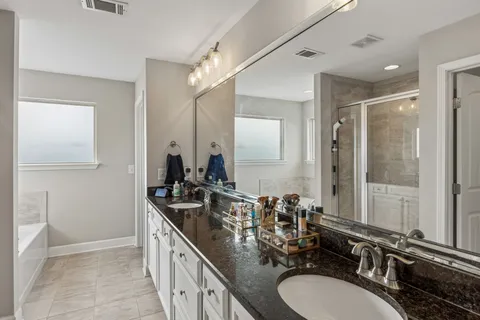 a bathroom with double sink and a mirror
