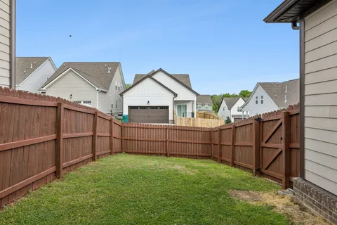 a view of a backyard with wooden fence
