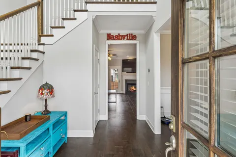 a view of hallway with wooden floor and stairs