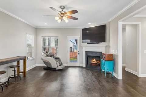 a living room with furniture fireplace and flat screen tv