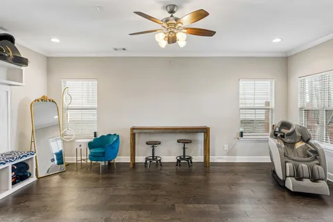 a living room with furniture and a wooden floor