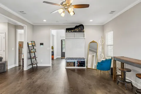 a view of a livingroom with furniture and a ceiling fan