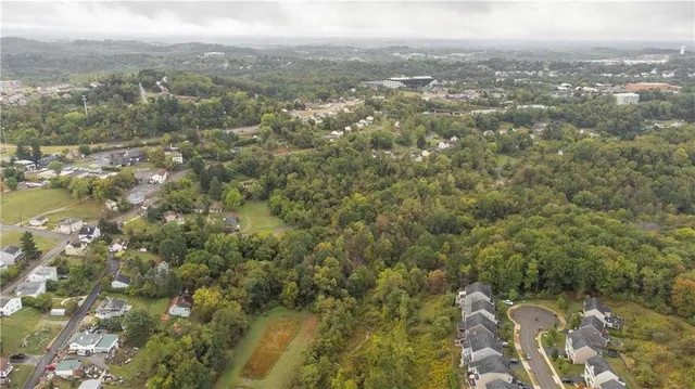 an aerial view of residential houses with city view