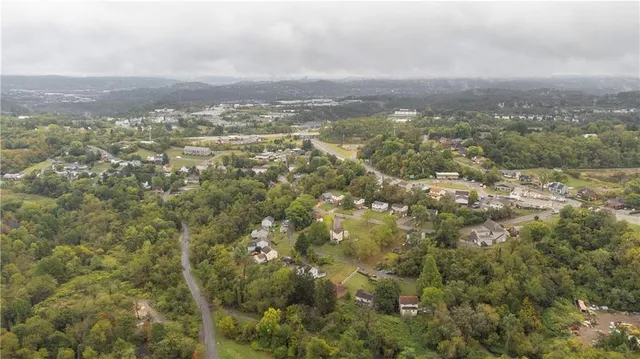an aerial view of residential houses with city view and mountain view