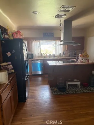 a kitchen with granite countertop a stove and a refrigerator