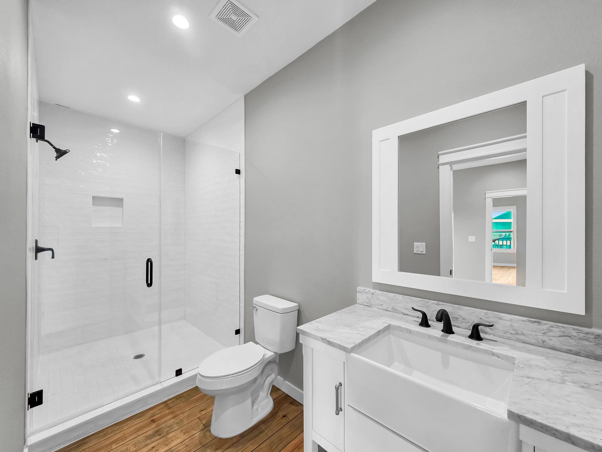 1041 Sunset Circle Crystal Beach, TX 77650 - Photo 27 of 45 a bathroom with a sink a toilet and shower