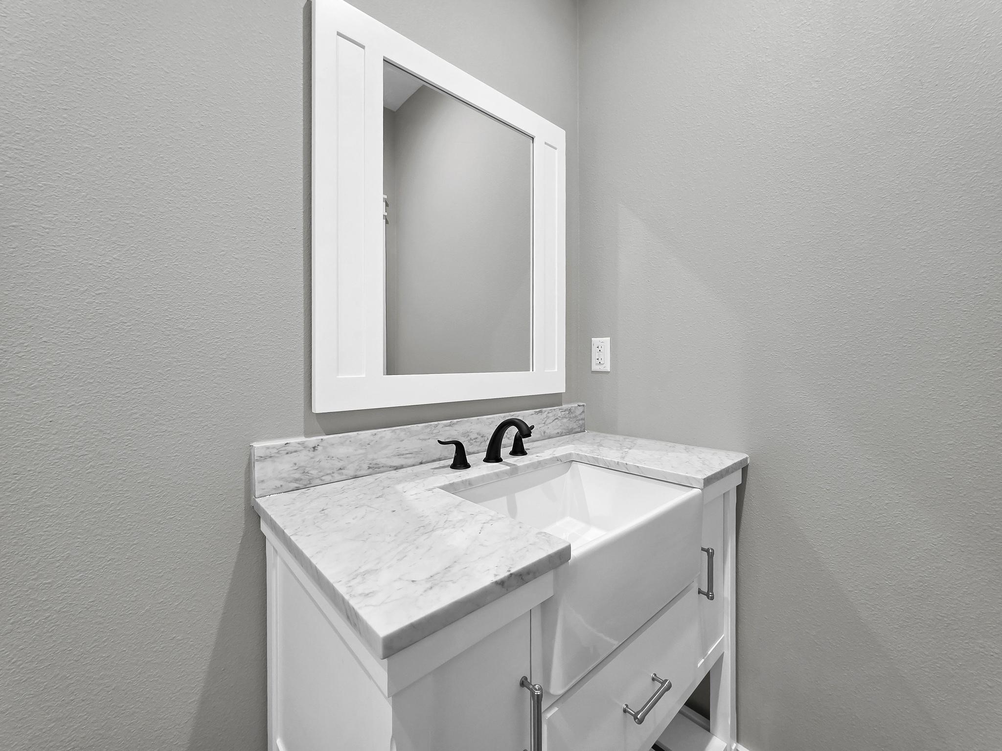 1041 Sunset Circle Crystal Beach, TX 77650 - Photo 28 of 45 a bathroom with a sink and a mirror